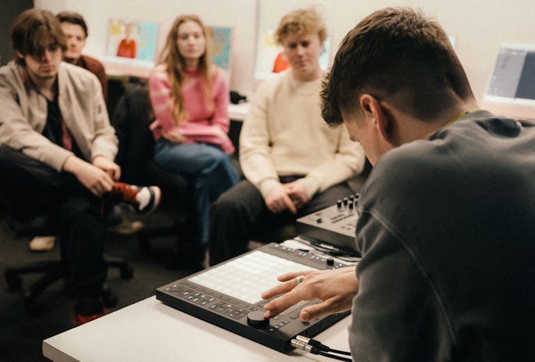 An educator demonstrating Push in front of a small group of students.